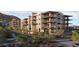 Upscale condo complex featuring desert landscaping, stone accents, multiple balconies, and modern architecture at 4849 N Camelback Ridge Rd # B308, Scottsdale, AZ 85251