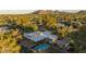 Overhead shot of a desert home with a swimming pool and lush green landscaping and mountain views at 4856 E Cheryl Dr, Paradise Valley, AZ 85253