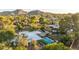 Stunning aerial view of home with mountain backdrop and swimming pool in lush green surroundings at 4856 E Cheryl Dr, Paradise Valley, AZ 85253