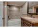 Bathroom featuring a tiled shower-tub combination, a granite vanity, and dark bronze fixtures at 4856 E Cheryl Dr, Paradise Valley, AZ 85253