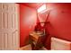 Unique red bathroom showcasing a modern glass sink, and a triangular mirror at 4856 E Cheryl Dr, Paradise Valley, AZ 85253