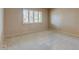 A clean and bright bedroom with neutral tones, shuttered window, and carpeted floor at 4856 E Cheryl Dr, Paradise Valley, AZ 85253