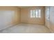 Bright bedroom with shuttered window and carpeted floors leading to a closed door at 4856 E Cheryl Dr, Paradise Valley, AZ 85253