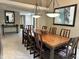 Formal dining room with large wood table, stylish light fixtures, and neutral decor at 4856 E Cheryl Dr, Paradise Valley, AZ 85253