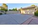 Long driveway and a modern, two-car garage with a beige facade and lush landscaping at 4856 E Cheryl Dr, Paradise Valley, AZ 85253