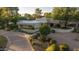 Stunning desert home featuring lush landscaping and a circular driveway at 4856 E Cheryl Dr, Paradise Valley, AZ 85253