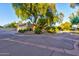Lovely landscaping, a circular driveway, and mature trees enhance the charm of the property at 4856 E Cheryl Dr, Paradise Valley, AZ 85253