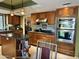 Well-appointed kitchen boasting stainless steel appliances, wood cabinets, and modern lighting at 4856 E Cheryl Dr, Paradise Valley, AZ 85253