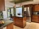 Well-lit kitchen featuring stainless steel appliances, a central island, and ample storage space at 4856 E Cheryl Dr, Paradise Valley, AZ 85253