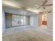 Bright living room featuring sliding doors to the patio, a ceiling fan, and an open layout to a bathroom at 4856 E Cheryl Dr, Paradise Valley, AZ 85253