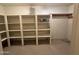 Spacious pantry with white shelving, some storage, and a speckled floor at 4856 E Cheryl Dr, Paradise Valley, AZ 85253