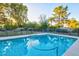 Backyard pool area featuring a safety fence and mature landscaping around the perimeter at 4856 E Cheryl Dr, Paradise Valley, AZ 85253