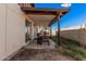This covered back patio provides shade, with a rustic table for outdoor dining at 5101 W Purdue Ave, Glendale, AZ 85302