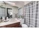 Cozy bathroom with a large mirror, vanity, and shower-tub combination at 5101 W Purdue Ave, Glendale, AZ 85302