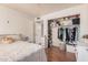 This bedroom features a closet, a plush bed, and bright lighting at 5101 W Purdue Ave, Glendale, AZ 85302