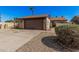Charming single-story home with a two-car garage, featuring a low-maintenance gravel yard and mature landscaping at 5101 W Purdue Ave, Glendale, AZ 85302