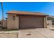 Home featuring a two-car garage, desert landscaping and a brick facade at 5101 W Purdue Ave, Glendale, AZ 85302