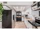 Well-lit kitchen with stainless steel appliances, butcher block counters and white cabinets at 5101 W Purdue Ave, Glendale, AZ 85302