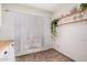 Bright nook area with large window, wooden shelf and decorative house plants at 5101 W Purdue Ave, Glendale, AZ 85302