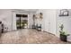 Bright living room with tiled floors and sliding glass doors to outdoor patio area at 5101 W Purdue Ave, Glendale, AZ 85302