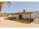 Charming backyard patio with beautiful flowers, landscaping, and desert style design at 5102 W Whispering Wind Dr, Glendale, AZ 85310