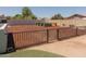 Backyard with garden beds, decorative wood chips, and secure fencing at 5102 W Whispering Wind Dr, Glendale, AZ 85310