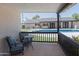Relaxing backyard patio with cushioned chairs overlooking a pool, grassy area, and the main house at 5102 W Whispering Wind Dr, Glendale, AZ 85310