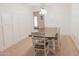 Dining room featuring wainscoting, wood-look floors and a rustic table at 5102 W Whispering Wind Dr, Glendale, AZ 85310