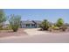 Charming single story home featuring a paved driveway, a dark roof, and mature landscaping at 5102 W Whispering Wind Dr, Glendale, AZ 85310