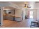 Open-concept living room features a modern kitchen, wood floors, and a bright entrance, creating an inviting space at 5102 W Whispering Wind Dr, Glendale, AZ 85310