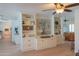 Bright living room features custom built-in shelving, wood floors, and an open floor plan at 5102 W Whispering Wind Dr, Glendale, AZ 85310