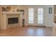 Bright living room featuring a stone fireplace and wood-look floors at 5102 W Whispering Wind Dr, Glendale, AZ 85310