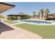 Backyard pool with covered patio, palm trees, and mountain views at 5102 W Whispering Wind Dr, Glendale, AZ 85310