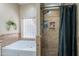 A tiled shower stall and soaking tub complement each other with their classic tile surround at 5127 W Dobbins Rd, Laveen, AZ 85339