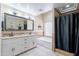 Well-lit bathroom featuring a double sink vanity, soaking tub, and separate tiled shower stall at 5127 W Dobbins Rd, Laveen, AZ 85339