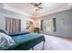 Comfortable bedroom featuring neutral walls, tray ceiling, ceiling fan, and two twin beds at 5127 W Dobbins Rd, Laveen, AZ 85339
