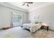 Charming bedroom with a ceiling fan, large window, and cozy decor at 5127 W Dobbins Rd, Laveen, AZ 85339