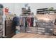 A view of a closet containing shelves with shoes and clothing at 5127 W Dobbins Rd, Laveen, AZ 85339