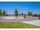 Secure gated property with a circular driveway and lush landscaping at 5127 W Dobbins Rd, Laveen, AZ 85339