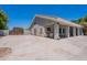 Wide shot of home's exterior featuring a large driveway and covered patio at 5127 W Dobbins Rd, Laveen, AZ 85339