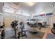 Spacious garage featuring three motorcycles, a car, gym equipment, and ample storage space at 5127 W Dobbins Rd, Laveen, AZ 85339