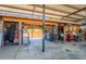 View of the garage with concrete flooring, tool storage, and equipment at 5127 W Dobbins Rd, Laveen, AZ 85339