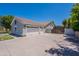 Property featuring a large driveway and a three-car garage at 5127 W Dobbins Rd, Laveen, AZ 85339
