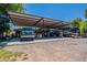 Wide exterior view of the garage area, with parking for trucks, RVs, and car lift at 5127 W Dobbins Rd, Laveen, AZ 85339