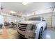 Bright garage featuring a silver Escalade SUV, open storage, and ample space at 5127 W Dobbins Rd, Laveen, AZ 85339