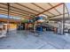 View of the garage with car lift, storage, RV and overhead beam structure at 5127 W Dobbins Rd, Laveen, AZ 85339
