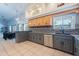 Spacious kitchen featuring stainless steel appliances, wood and gray cabinets, and tile floors at 5127 W Dobbins Rd, Laveen, AZ 85339