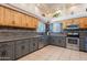 Spacious kitchen featuring two-tone cabinets, stainless steel appliances, and tile flooring at 5127 W Dobbins Rd, Laveen, AZ 85339