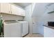 This laundry room features updated washer and dryer with a tile floor at 5127 W Dobbins Rd, Laveen, AZ 85339
