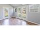 Bright room showcasing laminate floors, dual french doors leading to the outside, and a fresh coat of grey paint at 5127 W Dobbins Rd, Laveen, AZ 85339